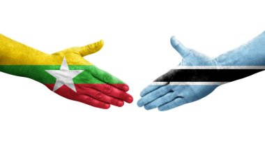 Botswana ve Myanmar bayrakları arasındaki el sıkışma ellerinde izole şeffaf görüntü.