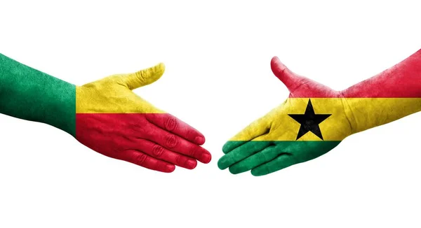 Stock image Handshake between Benin and Ghana flags painted on hands, isolated transparent image.