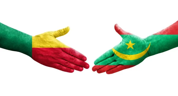 stock image Handshake between Benin and Mauritania flags painted on hands, isolated transparent image.