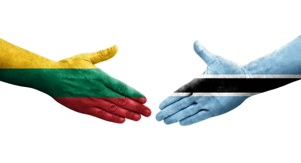 stock image Handshake between Botswana and Lithuania flags painted on hands, isolated transparent image.