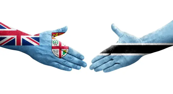 Handdruk Tussen Botswana Fiji Vlaggen Geschilderd Handen Geïsoleerd Transparant Beeld — Stockfoto