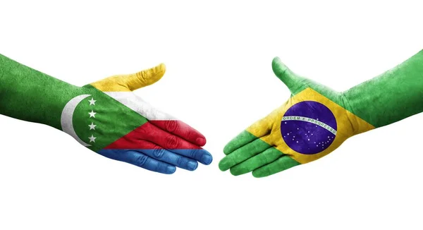手に描かれたブラジルとコモロの旗の間の握手 隔離された透明画像 — ストック写真