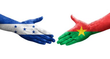 Ellerinde Burkina Faso ve Honduras bayrakları arasında el sıkışma, izole şeffaf görüntü.
