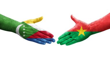Ellerinde Burkina Faso ve Comoros bayrakları arasında el sıkışma, izole şeffaf görüntü.