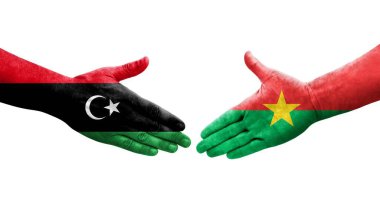 Ellerinde Burkina Faso ve Libya bayrakları arasında el sıkışma, izole şeffaf görüntü.