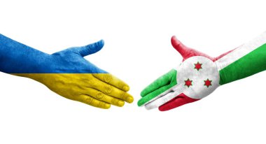 Ellerinde Burundi ve Ukrayna bayrakları arasında el sıkışma, izole şeffaf görüntü.