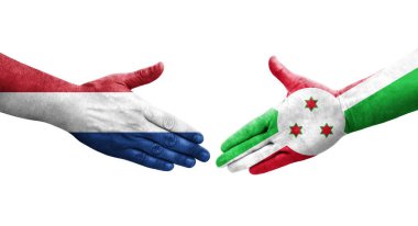 Ellerinde Burundi ve Hollanda bayrakları arasında el sıkışma, izole şeffaf görüntü.
