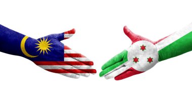 Ellerinde Burundi ve Malezya bayrakları arasında el sıkışma, izole şeffaf görüntü.
