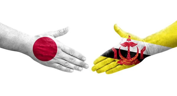 Handdruk Tussen Brunei Japan Vlaggen Geschilderd Handen Geïsoleerd Transparant Beeld — Stockfoto