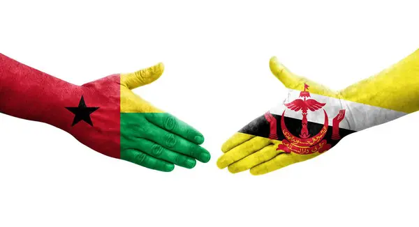 Stretta Mano Tra Brunei Guinea Bissau Bandiere Dipinte Mani Isolata — Foto Stock