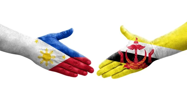 Handslag Mellan Brunei Och Filippinerna Flaggor Målade Händer Isolerad Transparent — Stockfoto