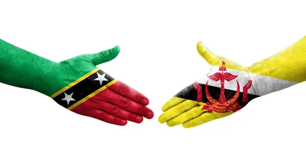 Handslag Mellan Brunei Och Saint Kitts Och Nevis Flaggor Målade — Stockfoto