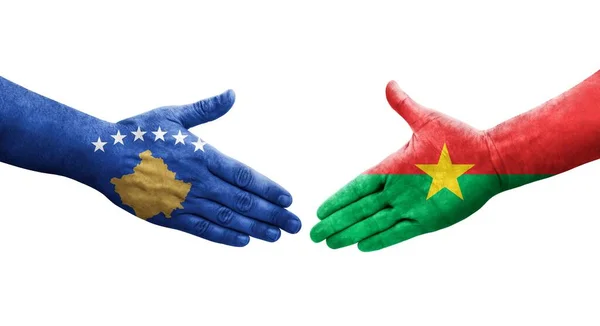 stock image Handshake between Burkina Faso and Kosovo flags painted on hands, isolated transparent image.