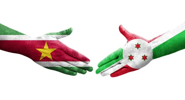 stock image Handshake between Burundi and Suriname flags painted on hands, isolated transparent image.