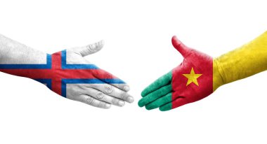 Kamerun ve Faroe Adaları bayrakları arasındaki el sıkışma, izole şeffaf görüntü.