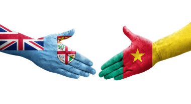 Kamerun ve Fiji bayrakları arasında el sıkışma, izole edilmiş şeffaf görüntü.