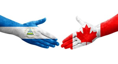 Ellerinde Kanada ve Nikaragua bayrakları arasında el sıkışma, izole şeffaf görüntü.