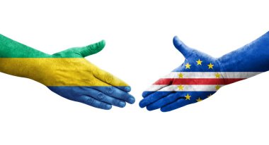 Cape Verde ve Gabon bayrakları arasındaki el sıkışma ellere boyanmış, izole şeffaf görüntü.