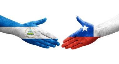 Şili ve Nikaragua bayrakları arasındaki el sıkışma ellerinde resmedilmiş şeffaf görüntü.