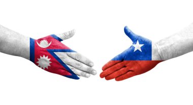 Ellere boyanmış Şili ve Nepal bayrakları arasındaki el sıkışma, izole edilmiş şeffaf görüntü.