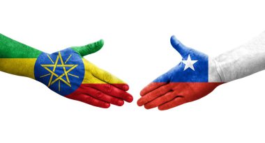 Ellere boyanmış Şili ve Etiyopya bayrakları arasındaki el sıkışma, izole şeffaf görüntü.
