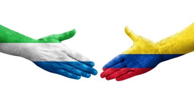 Kolombiya ve Sierra Leone bayrakları arasındaki el sıkışma ellerinde izole şeffaf görüntü.