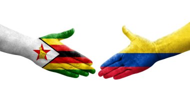 Kolombiya ve Zimbabwe bayrakları arasındaki el sıkışma ellerinde izole şeffaf görüntü.