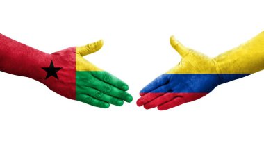 Kolombiya ve Gine Bissau bayrakları arasındaki el sıkışma..