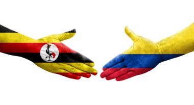 Kolombiya ve Uganda bayrakları arasındaki el sıkışma ellerinde izole şeffaf görüntü.