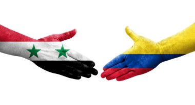Ellerinde Kolombiya ve Suriye bayrakları arasında el sıkışma, izole şeffaf görüntü.