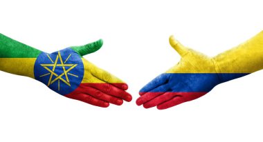 Kolombiya ve Etiyopya bayrakları arasındaki el sıkışma ellerinde izole şeffaf görüntü.