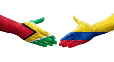 Kolombiya ve Guyana bayrakları arasındaki el sıkışma ellerinde izole şeffaf görüntü.