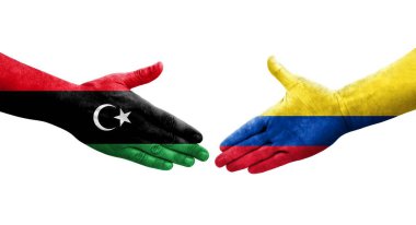 Ellerinde Kolombiya ve Libya bayrakları arasında el sıkışma, izole saydam görüntü.