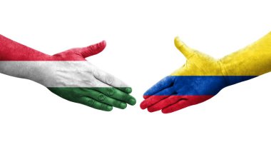Ellerinde Kolombiya ve Macaristan bayrakları arasında el sıkışma, izole şeffaf görüntü.