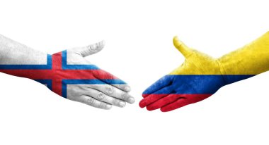 Kolombiya ve Faroe Adaları arasındaki el sıkışma ellerinde boyanmış bayraklar, izole şeffaf görüntü.