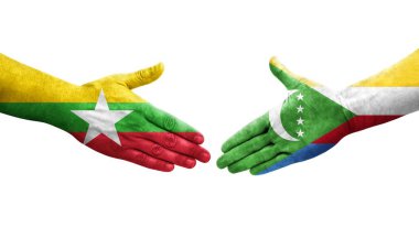 Ellerinde Comoros ve Myanmar bayrakları arasında el sıkışma, izole şeffaf görüntü.