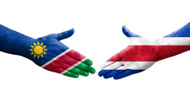 Ellerinde Kosta Rika ve Namibya bayrakları arasında el sıkışma, izole şeffaf görüntü.