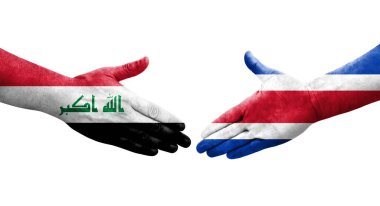 Ellerinde Kosta Rika ve Irak bayrakları arasında el sıkışma, izole şeffaf görüntü.