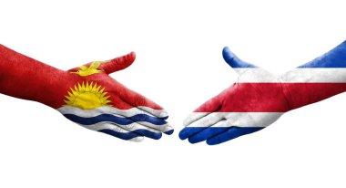 Ellerinde Kosta Rika ve Kiribati bayrakları arasında el sıkışma, izole şeffaf görüntü.