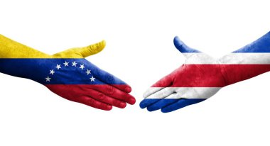 Ellerinde Kosta Rika ve Venezuela bayrakları arasında el sıkışma, izole şeffaf görüntü.