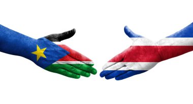 Ellerinde Kosta Rika ve Güney Sudan bayrakları arasında el sıkışma, izole şeffaf görüntü.