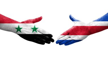 Ellerinde Kosta Rika ve Suriye bayrakları arasında el sıkışma, izole şeffaf görüntü.