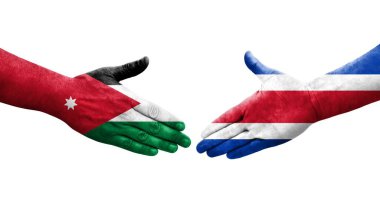 Ellerinde Kosta Rika ve Ürdün bayrakları arasında el sıkışma, izole şeffaf görüntü.