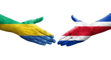 Ellerinde Kosta Rika ve Gabon bayrakları arasında el sıkışma, izole şeffaf görüntü.