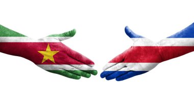 Kosta Rika ile Surinam bayrakları arasındaki el sıkışma, izole şeffaf görüntü.