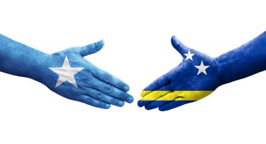Curacao ve Somali bayrakları arasındaki tokalaşma elleri boyalı, izole şeffaf görüntü.