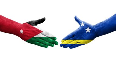 Curacao ve Ürdün bayrakları arasındaki el sıkışma ellerde resmedilmiş, şeffaf görüntü.