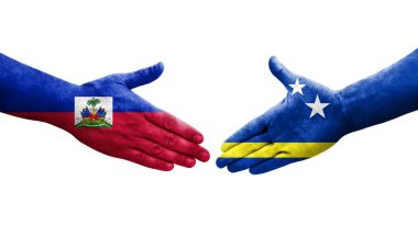 Curacao ve Haiti bayrakları arasındaki el sıkışma ellerinde resmedilmiş şeffaf görüntü.