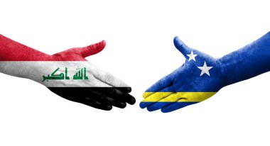 Curacao ve Irak bayrakları arasındaki el sıkışma, izole şeffaf görüntü.