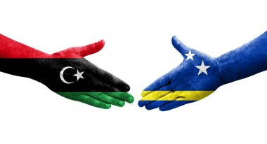 Curacao ve Libya bayrakları arasındaki el sıkışma, izole edilmiş şeffaf görüntü.